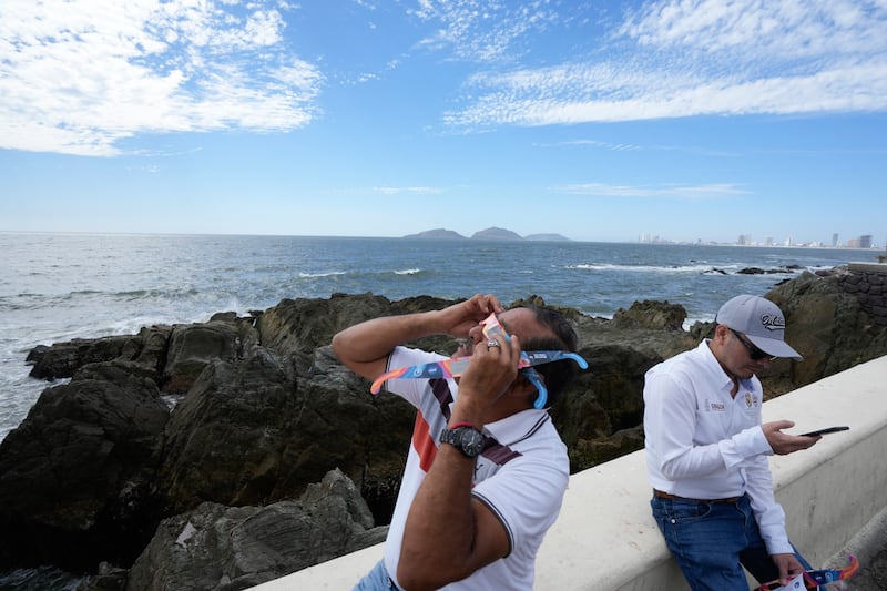 A man tests special glasses in preparation for viewing the upcoming solar total eclipse in Mazatlan, Mexico (Fernando Llano/AP)