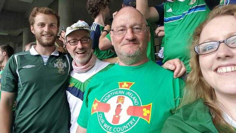 Ben Crossley, left, pictured in the stands at the Northern Ireland v Ukraine match in Lyon on June 16. He returned via air ambulance to the Ulster Hospital after suffering a horrific three-storey fall in France