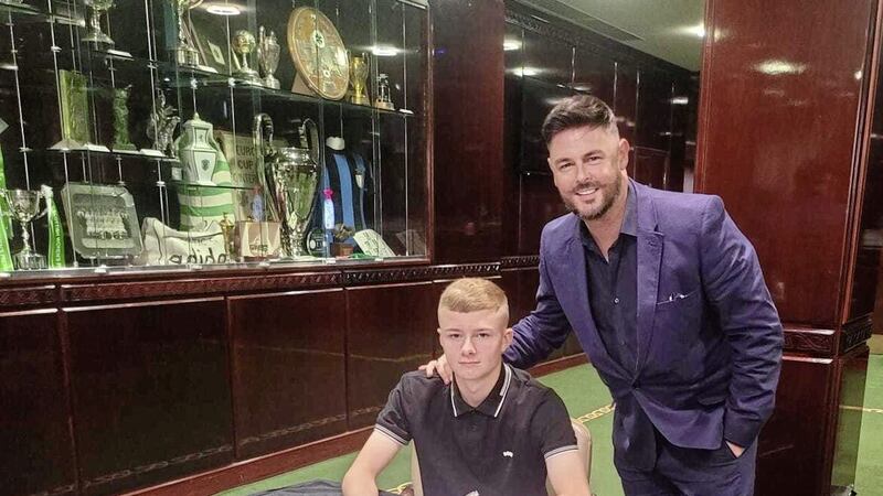 Belfast lad Francis Turley in the trophy room at Celtic as he signs for the Glasgow giants from Glentoran, pictured with his agent Lee Mudd of CAA Base. The technically gifted midfielder has impressed for Northern Ireland in this year&#39;s Victory Shield games. 
