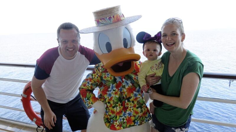 Wesley Johnson meets Donald Duck on board the Disney Dream cruise ship with his wife Carla and daughter Evie 