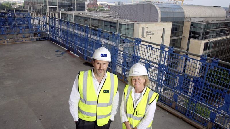 Adding to an improving picture for the north&#39;s construction sector, building work has resumed at Ulster University&#39;s flagship Belfast campus. The university&rsquo;s chief operating officer Niamh Lamond and Ant&oacute;nio Teixeira, operations director at SACYR Somague UK, are picturing assessing progress on the site, which will house more than 15,000 students and staff when it opens. Photo: Darren Kidd/PressEye 