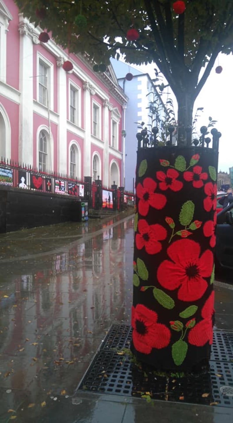 Knitted remembrance poppies decorate trees, railings, bollards and bus stops in haverfordwest ahead of Armistice Day