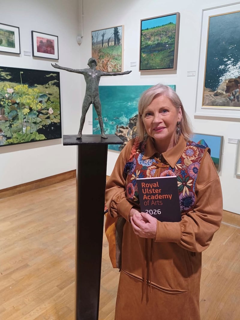 Noelle McAlinden beside Anthony Scott’s Redemption, one of the exhibits in the 145th Royal Ulster Academy exhibition