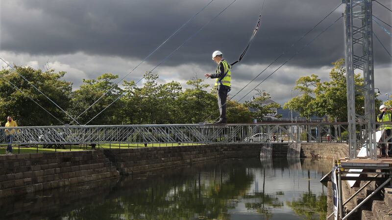 A man on the Meccano Bridge built by Queen's University Civil Engineering students in Belfast