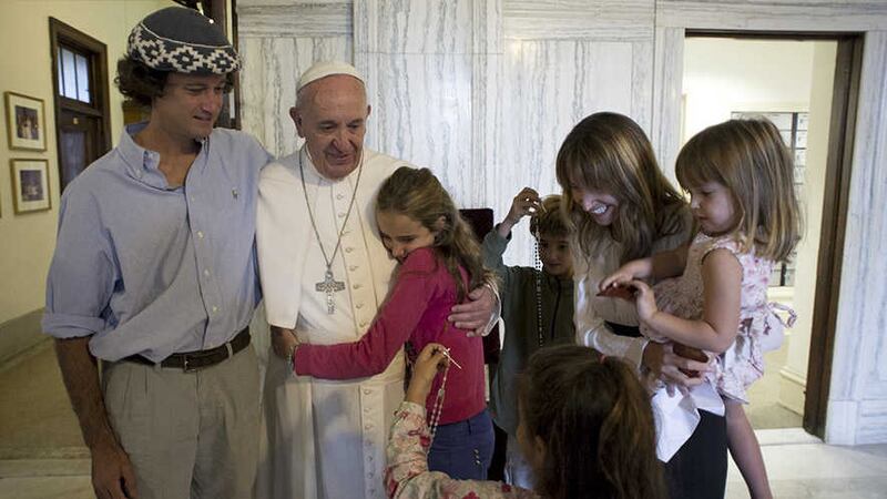 Pope Francis poses for a family photo with, Catire Walker, left, Noel Zemboiran, second from right, and their children, from left, Cala, Dimas, Mia and Carmin during a meeting at the Saint Charles Borromeo Seminary, in Philadelphia