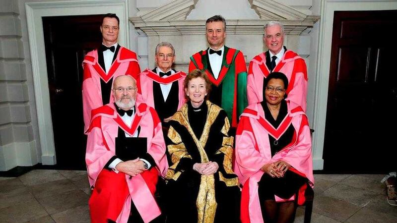 Fr Peter McVerry (back row, far right) and honorary degree recipients with Trinity chancellor Mary Robinson 