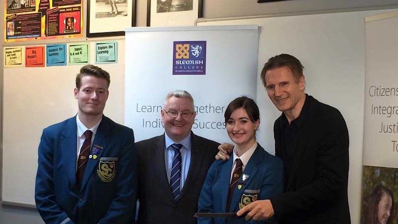 Liam Neeson with, from left, Slemish College head boy Conor Lunnun, principal Dr Paul McHugh and head girl Abigail Fletcher. Picture by Slemish College&nbsp;