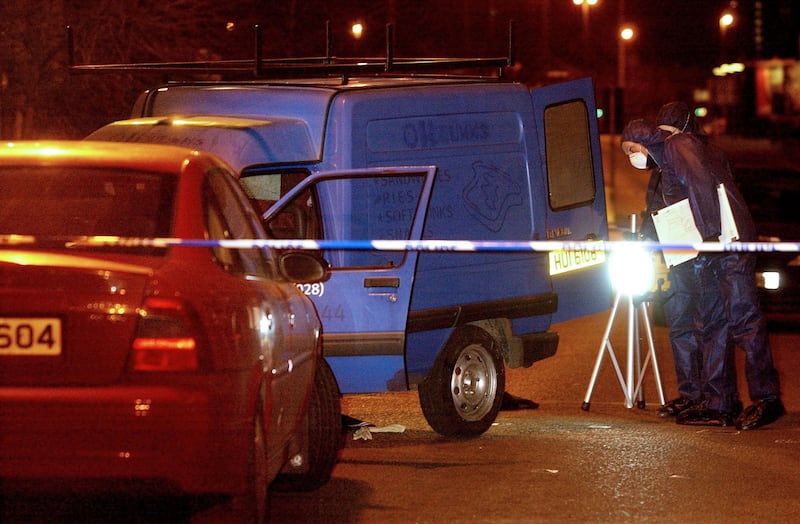 Police forensic officers examine the blue van in which republican Bobby Tohill was being abducted
