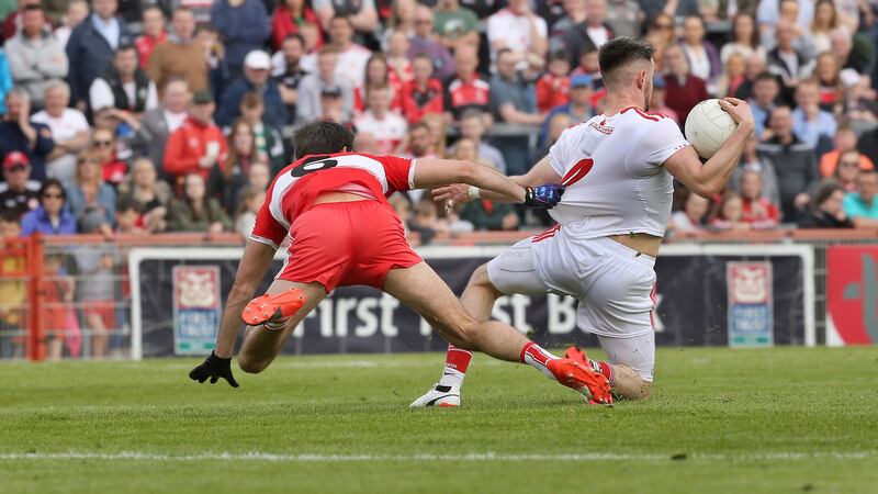 Chrissy McKaigue of Derry tries to stop Tyrone's Mattie Donnelly during Sunday's Ulster Senior Football Championship match at Healy Park.&nbsp;<span style="font-family: 'Lucida Grande', 'Lucida Sans Unicode', 'Lucida Sans', LucidaGrande, Geneva, Arial, Verdana, sans-serif;">Tyrone emerged victors, but the intensity and competitiveness of the game belied the fact that the Red Hands competed in Division One this season and the Oak Leafers in Division Four&nbsp;</span>Picture by Margaret McLaughlin