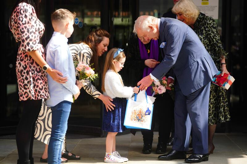 The King is presented with a bouquet as he leaves following a visit to University College Hospital Macmillan Cancer Centre in London [