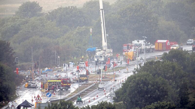 DISASTER: A giant crane is used to remove debris on the A27 at Shoreham in West Sussex where 11 people are believed to have died when an historic Hawker Hunter fighter jet plummeted onto the major south coast road after failing to pull out of a loop manoeuvre 									       PICTURE: Steve Parsons/PA&nbsp;