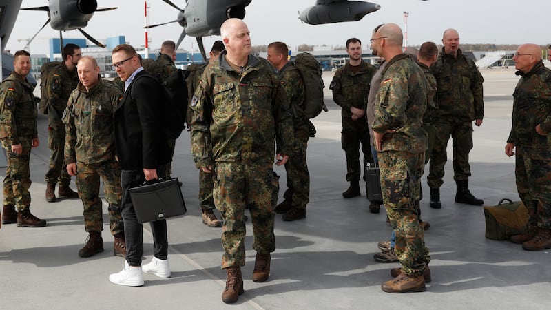 German Bundeswehr soldiers of the Headquarters initial command element of the Bundeswehr’s 45th Brigade Lithuania arrive at an airport in Vilnius, Lithuania (Mindaugas Kulbis/AP)