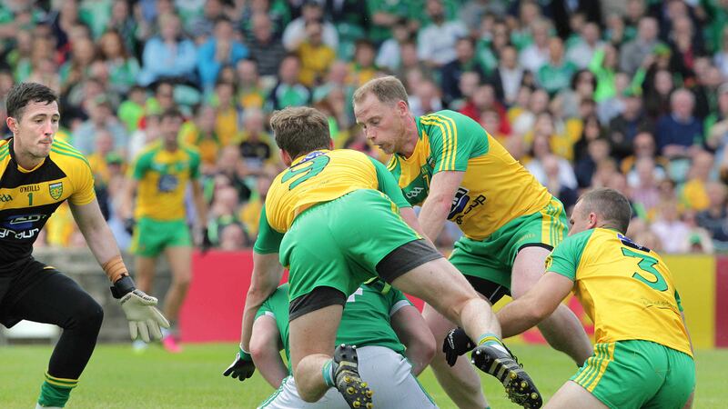 Donegal's Mark Anthony McGinley, Hugh McFadden, Anthony Thompson and Neil McGee swarm around Sean Quigley of Fermanagh during Sunday's Ulster Senior Championship quarter-final match at Ballybofey Picture by Margaret McLaughlin&nbsp;
