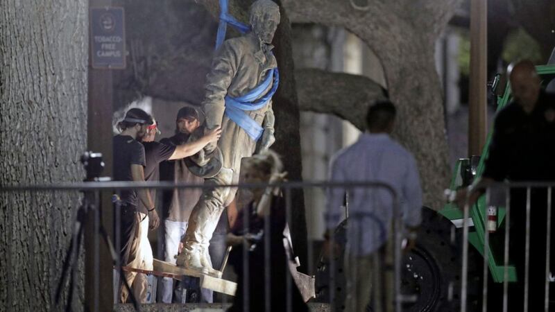 A statue of Confederate General Robert E. Lee is removed from the University of Texas campus. The university said it was moving the statues because they have become &quot;symbols of modern white supremacy and neo-Nazism&quot;. Picture by AP Photo/Eric Gay. 