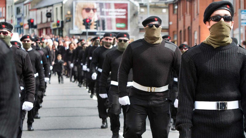 Men in paramilitary style uniform march through Derry during the funeral procession of Peggy O'Hara in July. Picture by Margaret McLaughlin