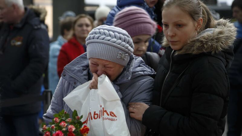 People react as they come to lay flowers and toys at an entrance of Pulkovo airport outside St Petersburg, Russia, during a day of national mourning for the plane crash victims. Picture by Dmitry Lovetsky/AP&nbsp;