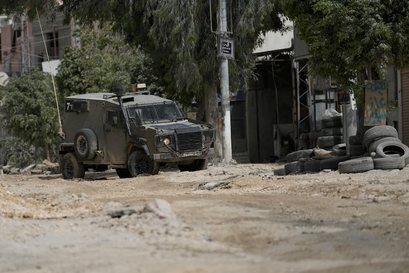 An Israeli military vehicle drives near the West Bank town of Tulkarem (Majdi Mohammed/AP)