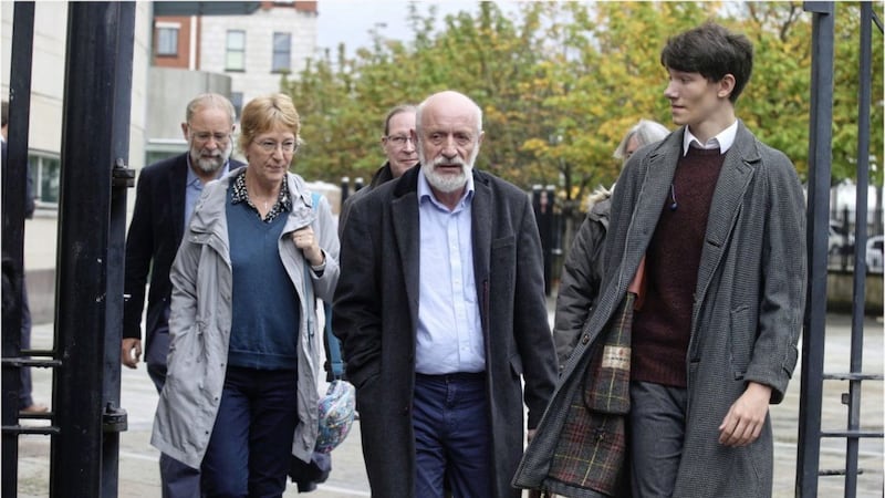 Charles Little, son-in-law Michael and Marjorie Cawdery, leads the family out of Laganside Court following yesterday&#39;s hearing. An inquest into the couple&#39;s killings will take place in 2021. Picture by Hugh Russell 