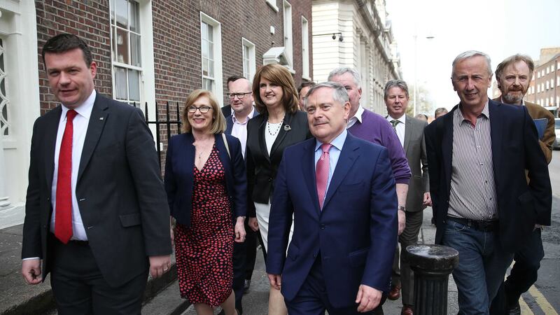 Former Tanaiste Joan Burton, centre, &nbsp;surrounded by party colleagues on her way to a press conference at the RHA Gallery in Dublin where she announced she would be stepping down as Labour party leader. Picture by Brian Lawless, Press Association