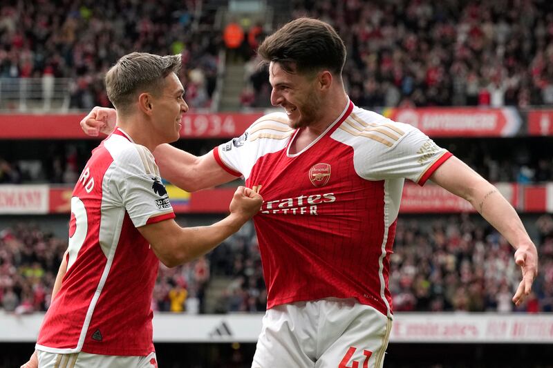 Arsenal’s Leandro Trossard, left, celebrates with Declan Rice after scoring the second goal in the win over Bournemouth (Frank Augstein/AP)