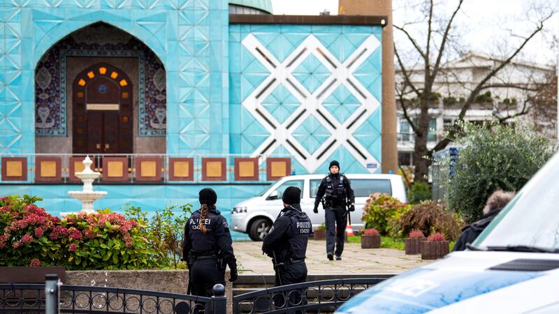 Police officers stand in front of the Imam Ali Mosque in Hamburg (Daniel Bockwoldt/dpa/AP)