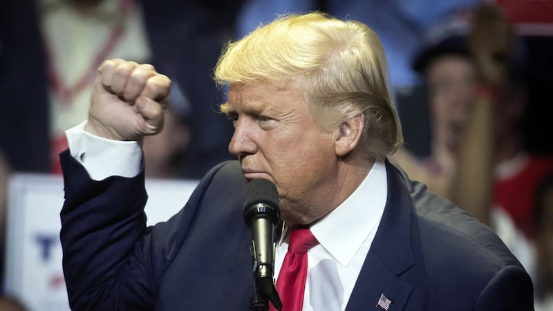 Republican presidential candidate Donald Trump raises his fist during a campaign rally in Cincinnati. Picture by John Minchillo, Associated Press