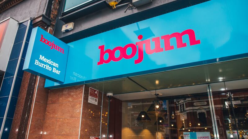 Exterior photo of a Boojum outlet, looking up at its signage of red font on blue hoarding.