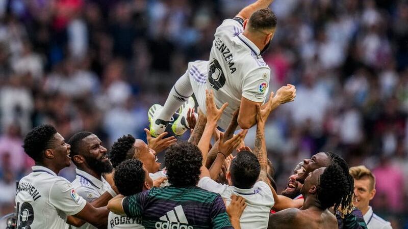 Karim Benzema is thrown in the air by his Real Madrid team-mates (Bernat Armangue/AP).