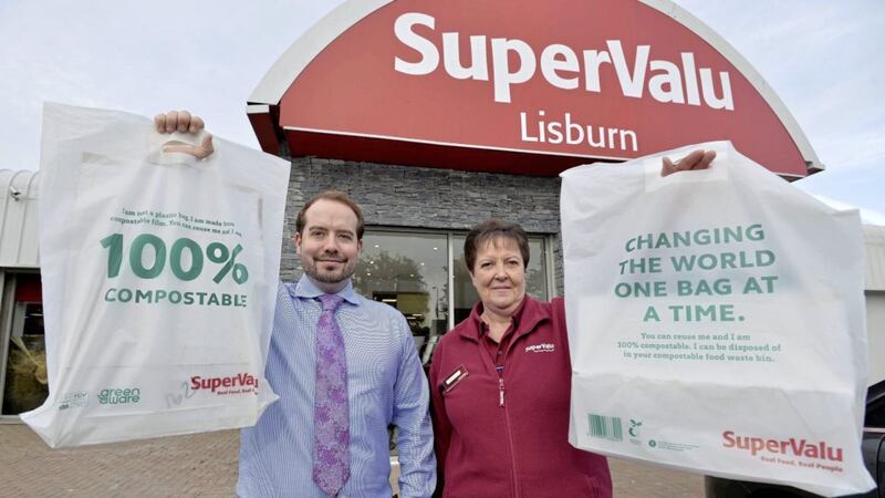 Jamie Graham (manager) and Deirdre Fegan from SuperValu Lisburn show off the 100 per cent compostable and reusable shopping bags which will be introduced across stores this week as part of the retailer&#39;s overall sustainability strategy 