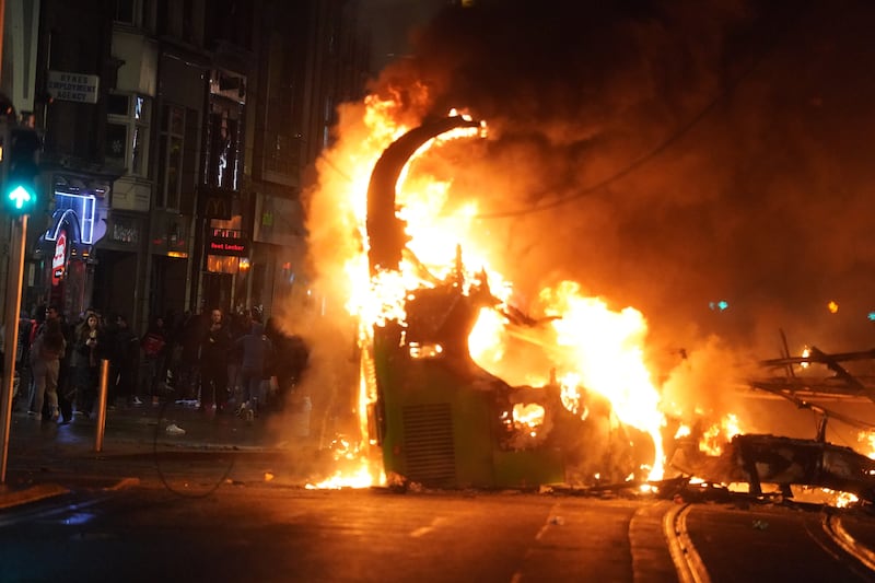 A bus on fire on O’Connell Street in Dublin city centre after violent scenes unfolded following an attack in Parnell Square East (Brian Lawless/PA)