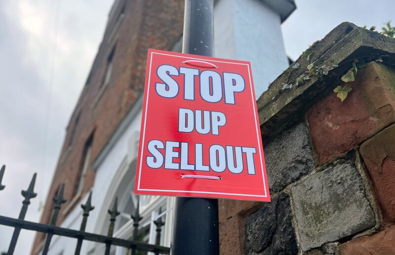 A poster stating “Stop DUP sellout” on a lamppost near Hillsborough Castle