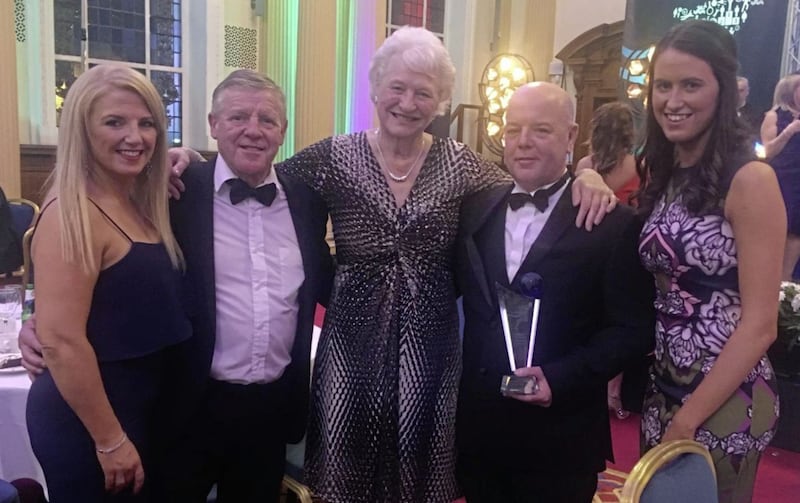 Holy Trinity coach Pete Brady picks up his coach of the year award at Belfast city hall on Saturday night. Also pictured are, from left, Emma-Louise Lowe (strategic development manager, Holy Trinity), Michael Hawkins (Holy Trinity head coach), Dame Mary Peters and Lynne Wilson (sports development officer, Belfast City Council) 