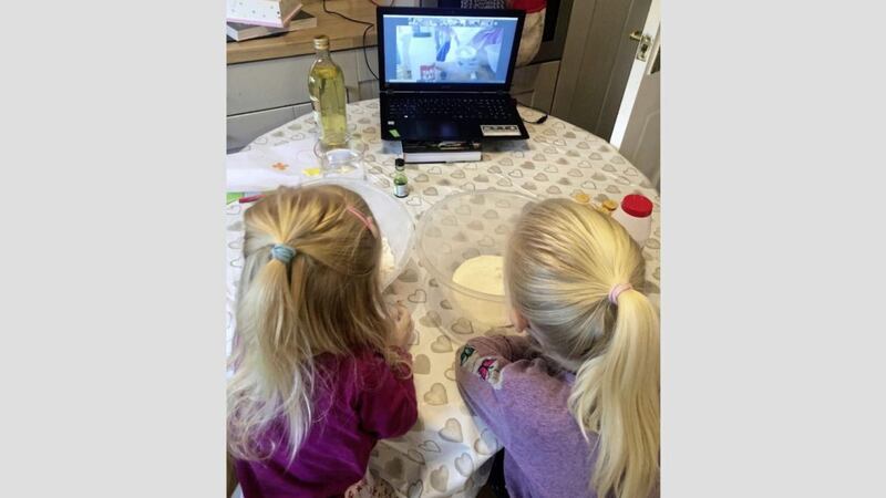 Two little girls learn how to make play dough with a Home-Start volunteer on Zoom visit 