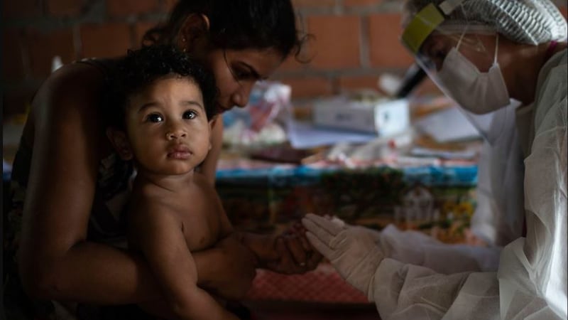 &nbsp;A health worker tests 1-year-old Nicolas for Covid-19 at his home after a family member fell ill in Manacapuru, Amazonas state, Brazil, on June 3 2020.&nbsp;Nicolas didn't show any symptoms but tested positive on the quick test. Picture by&nbsp;Felipe Dana, AP