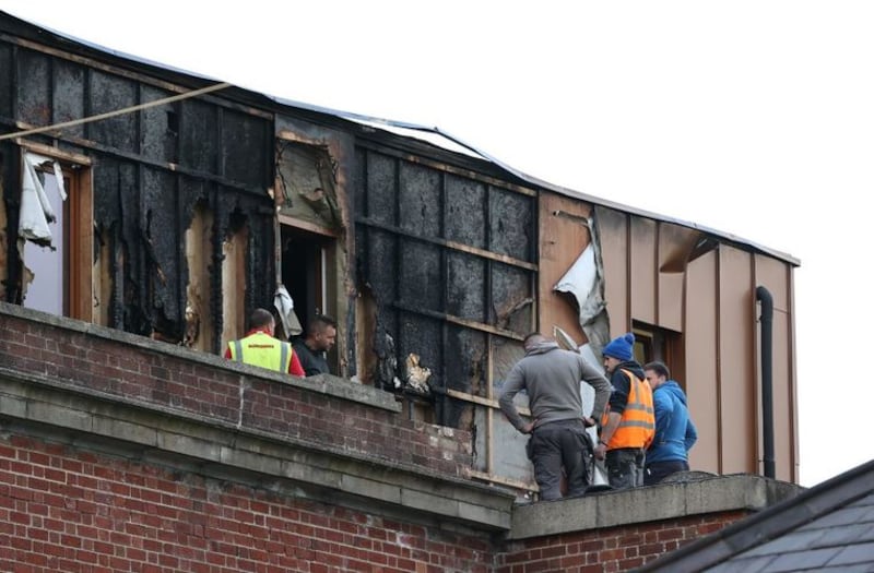 &nbsp;Workers clear debris around the Malone Exchange on the Lisburn Road, Belfast, where there was a fire in the building's penthouse earlier on Tuesday. Over 40 firefighters attended the scene. Picture date: Tuesday May 18, 2021.
