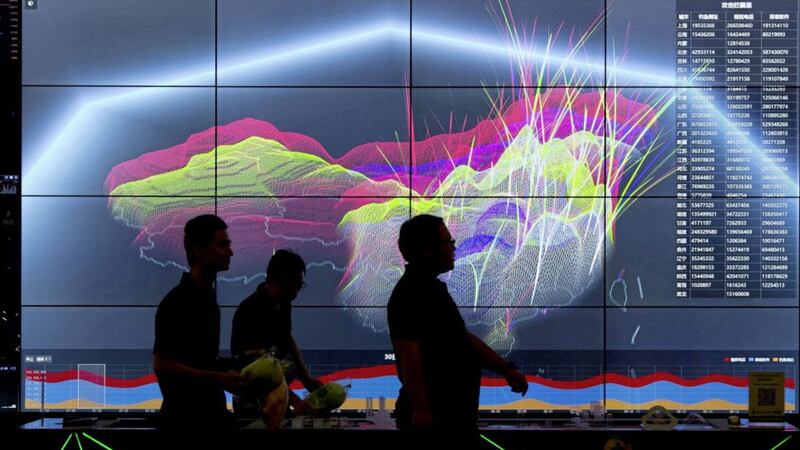 Attendees walk past a live visualization of internet attacks across China during the 4th China Internet Security Conference (ISC) in Beijing Picture by Ng Han Guan/AP 
