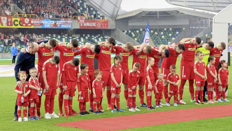 Cliftonville&#39;s players bowed their heads during the playing of God Save the Queen before the Irish Cup final at Windsor Park on Saturday 