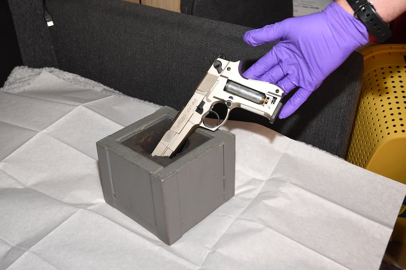 A silver handgun found during the raids.