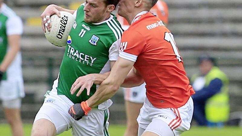 Mark Shields attempts to hold up Declan McCusker during Saturday night&#39;s Ulster Championship clash at Brewster Park. Picture by Philip Walsh 