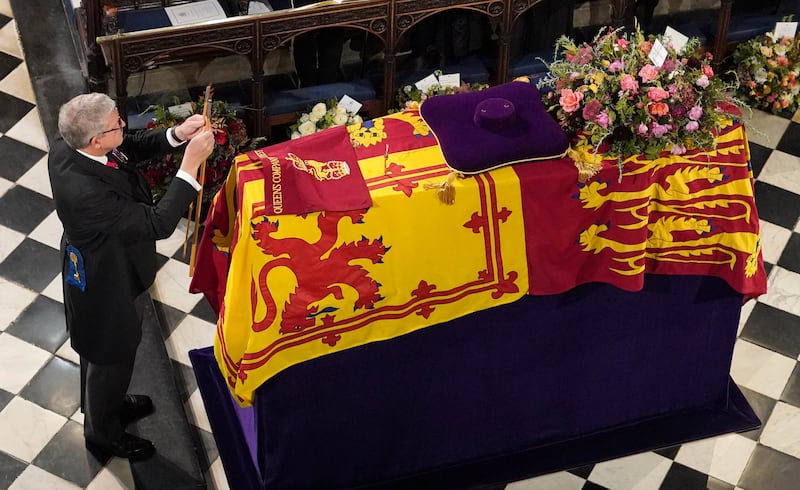 The Lord Chamberlain Baron Parker ceremonially breaks his Wand of Office as he stands in front of the late Queen’s coffin in St George’s Chapel