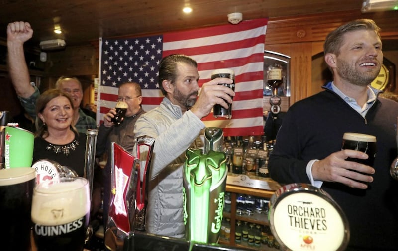 Donald Trump Jr. (centre), and Eric Trump (right), the sons of US President Donald Trump, behind the bar in Tubridy's Bar in the village of Doonbeg, Co Clare, on the first day of US President Donald Trump's visit to the Republic. Picture by Brian Lawless/PA Wire