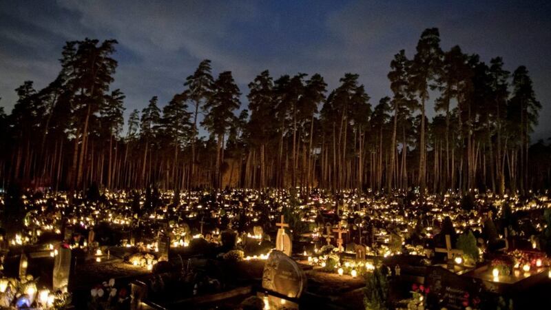 Candles, traditionally lit in November to remember dead relatives and those who have gone before us, seem to burn with an extra intensity in these days of coronavirus. Pictured is a cemetery in Vilnius, Lithuania. Picture by AP Photo/Mindaugas Kulbis 