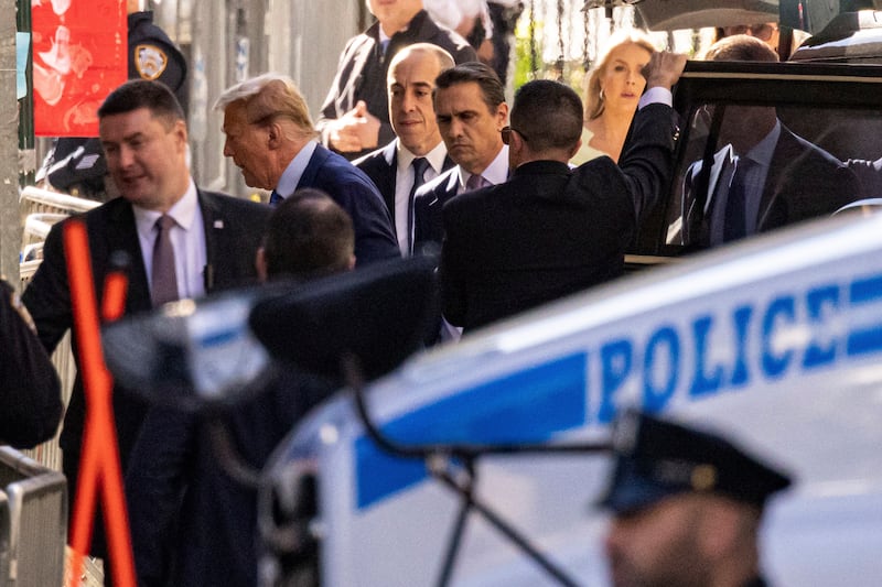 Donald Trump, second from left, arrives at Manhattan Criminal Court in New York (Yuki Iwamura/AP)