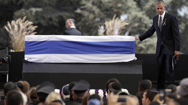 US president Barack Obama touches the casket of former Israeli President Shimon Peres after speaking during his funeral at Mount Herzl national cemetery in Jerusalem. Picture by /Carolyn Kaster/Associated Press