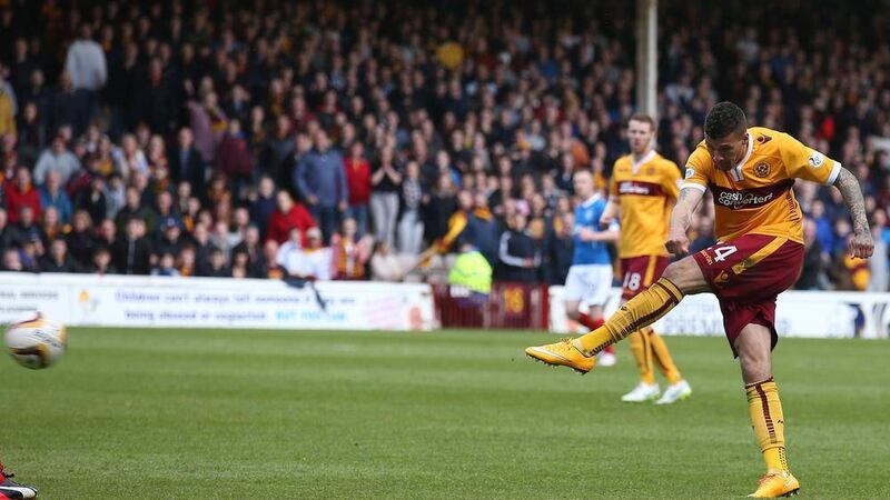 Motherwell&#39;s Marvin Johnson opens the scoring at Fir Park on Sunday as the Well confirmed their status as a Scottish Premiership side Picture: PA 
