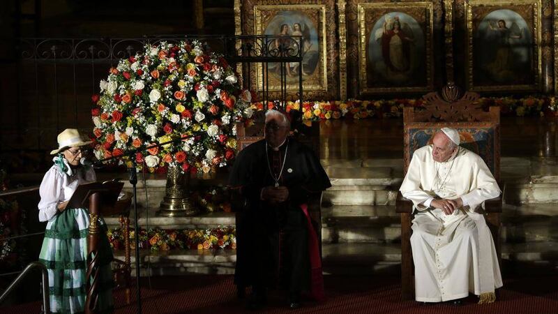 Pope Francis listens to a speech by Imelda Caicedo, pictured left, a delegate of the Ecuadorian coastal farmers association, during his visit to the San Francisco Church in Quito, Ecuador 