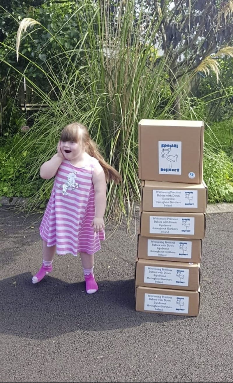 Aoife helps load up the gift boxes that she helped to inspire. The boxes are filled with handmade blankets, hats and cardigans, as well as books full of positive information about Down&#39;s syndrome 