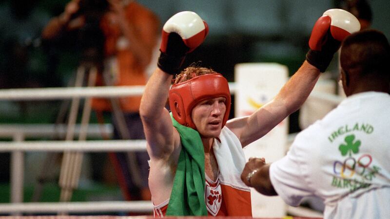 Ireland's Michael Carruth raises his arms in victory as he walks back to his cornermen, his father Austin and Nicholas Hernandez Cruz, after winning the 1992 Olympic Games gold medal with victory over Cuba's Juan Hernandez in the welterweight final in Barcelona&nbsp;
