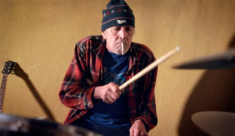 A photo of Gary Young showing off his drumming skills in a scene from the documentary Louder Than You Think
