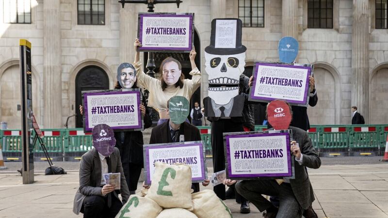 Protestors wearing Andrew Bailey and Rishi Sunak masks outside the Bank of England in London ahead of the announcement on interest rates 